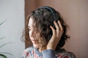 girl listening to music on headphones