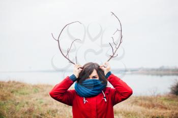 woman with antlers is smiling