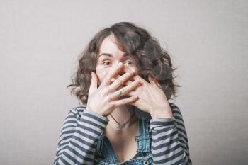 young woman covering mouth after vulgar jokes