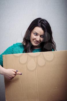 woman with empty cardboard. On a gray background.