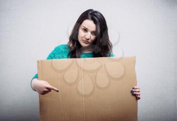 woman with empty cardboard. On a gray background.