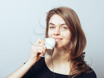 merry cute brunette girl drinking coffee