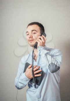 Man holding a telephone tube and smiling