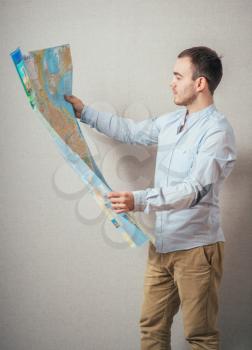 Tourist man looking at map against 