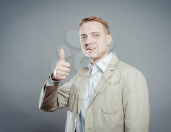 Smiling businessman with thumb up