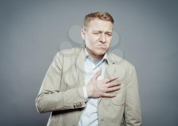 Businessman with hands on  his chest. hearts pain