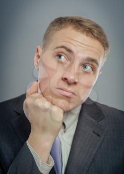 Closeup of a handsome young business man thinking