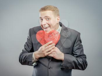 Man holding a red  heart concept for valentine's day, business customer care, charity, social and corporate responsibility