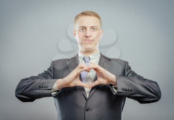 Happy businessman with love gesture