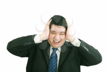 Frustrated young businessman pulling his hair, studio shot 
