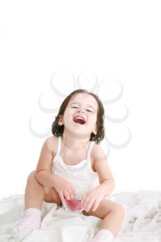 laughing little girl on her bed