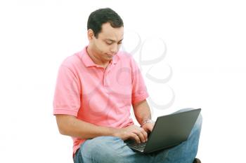 Young man sitting on the floor and work with laptop computer 
