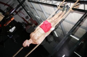 Crossfit Rope Training on a dark background.