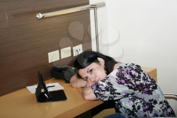 Young businesswoman leaning at the office