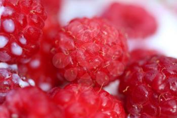 A background of ripe red raspberry with milk