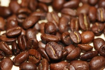 Macro shot of roasted coffee grains on a table