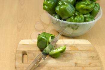 Royalty Free Photo of Green Peppers on a Cutting Board