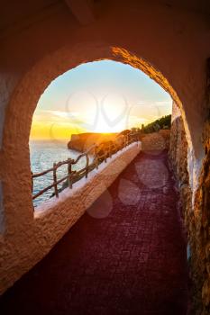 COVA D'EN XOROI - JUNE 11: Sunset viewed from Cova d'en Xoroi bar on June 11, 2013 in Cala En Porter, Menorca, Spain. It was set within natural caves with the beautiful view on Mediterranean sea.