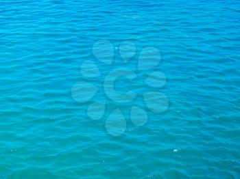 Blue tranquil sea water background.