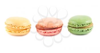 Colorful french macaroons in a row isolated on white background