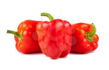 Three red ripe sweet bulgarian peppers isolated on white background