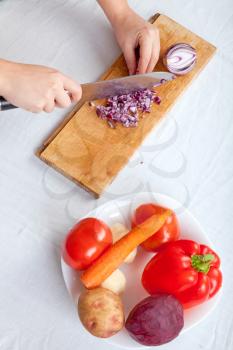 Royalty Free Photo of a Woman Cutting an Onion