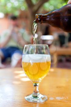 Royalty Free Photo of a Bottle of Beer Being Poured at a Bar