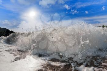 Big wave front with bubbles and splashes closeup view

