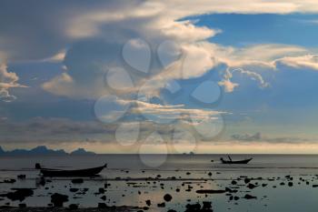 Two boat silhouettes at sunset on Koh Samui island, Thailand

