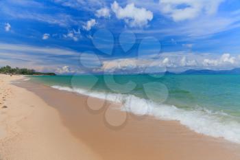 Blue sky and sand beach with wakeboarder sailing in the open sea. Koh Samui, Thailand
