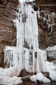 Frozen water with icicles in waterfall
