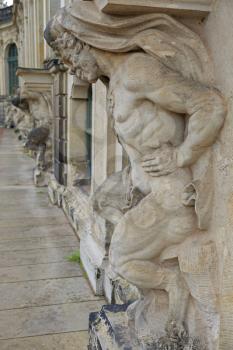 Closeup half naked satyr statues row at Zwinger palace in Dresden, Germany
