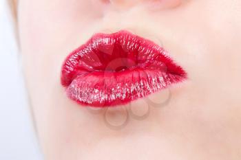 Woman face and lips with red lipstick
