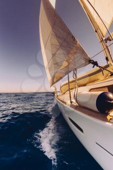 Sailing boat wide angle view in the sea, instagram toning at sunset
