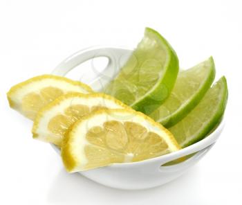 Royalty Free Photo of Lime and Lemon Slices in a White Dish