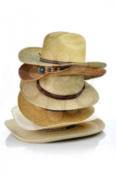 a stack of vintage straw hats