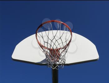 basketball hoop against a blue sky
