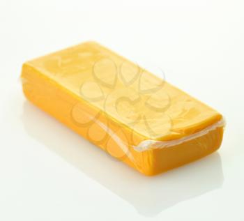 A block of sharp cheddar in a vacuum package 