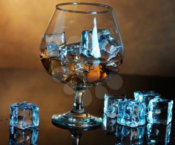 glass of whiskey with ice cubes