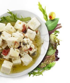 Feta Cheese With Olive Oil , Herbs And Fresh Salad Leaves
