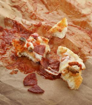 Leftover Pizza On The Paper With Tomato Sauce