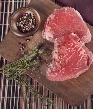 Raw Sirlion Steaks with Hirbs and Spices