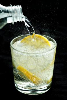 Drink with lemon, black background