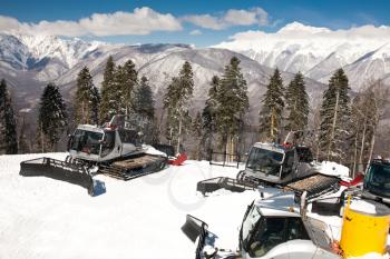 Snowplows, montains on background