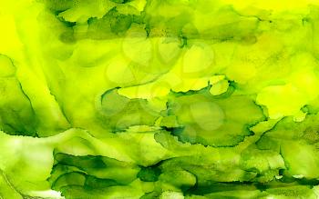 Abstract paint yellow green uneven.Colorful background hand drawn with bright inks and watercolor paints. Color splashes and splatters create uneven artistic modern design.