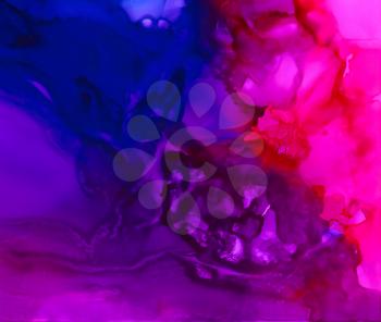 Bright purple merging with blue smooth paint.Colorful background hand drawn with bright inks and watercolor paints. Color splashes and splatters create uneven artistic modern design.