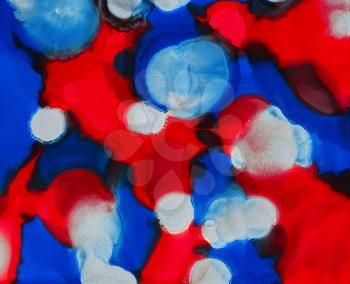 Red blue white uneven color spots.Colorful background hand drawn with bright inks and watercolor paints. Color splashes and splatters create uneven artistic modern design.