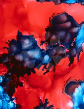 Scarlet red uneven cloudy texture over deep blue.Colorful background hand drawn with bright inks and watercolor paints. Color splashes and splatters create uneven artistic modern design.