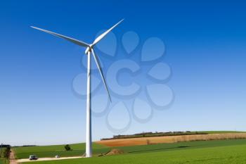 A wind turbine under clear blue sky