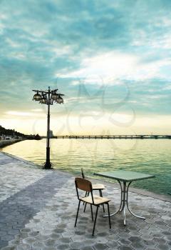 Royalty Free Photo of a Patio Set on the Water